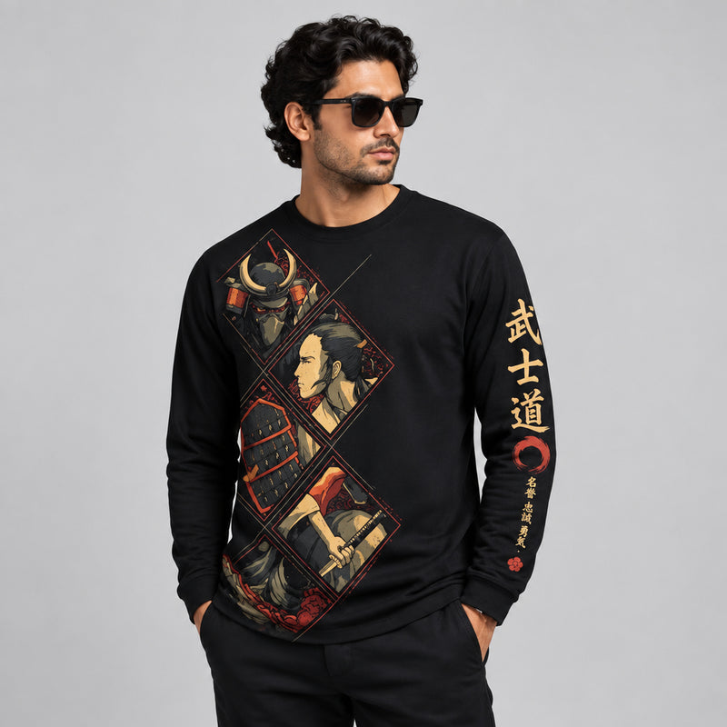 A man wearing a black long-sleeve crewneck sweatshirt with a large graphic print on the front and gold Japanese characters on the sleeve, set against a dark gray background.